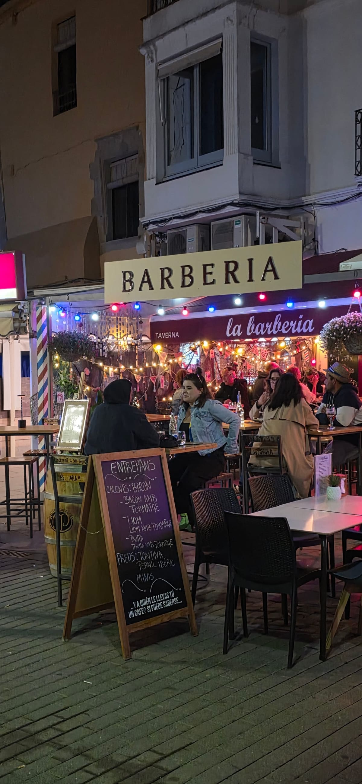The la barberia taverna in the Palamós old town, strung with fairy lights